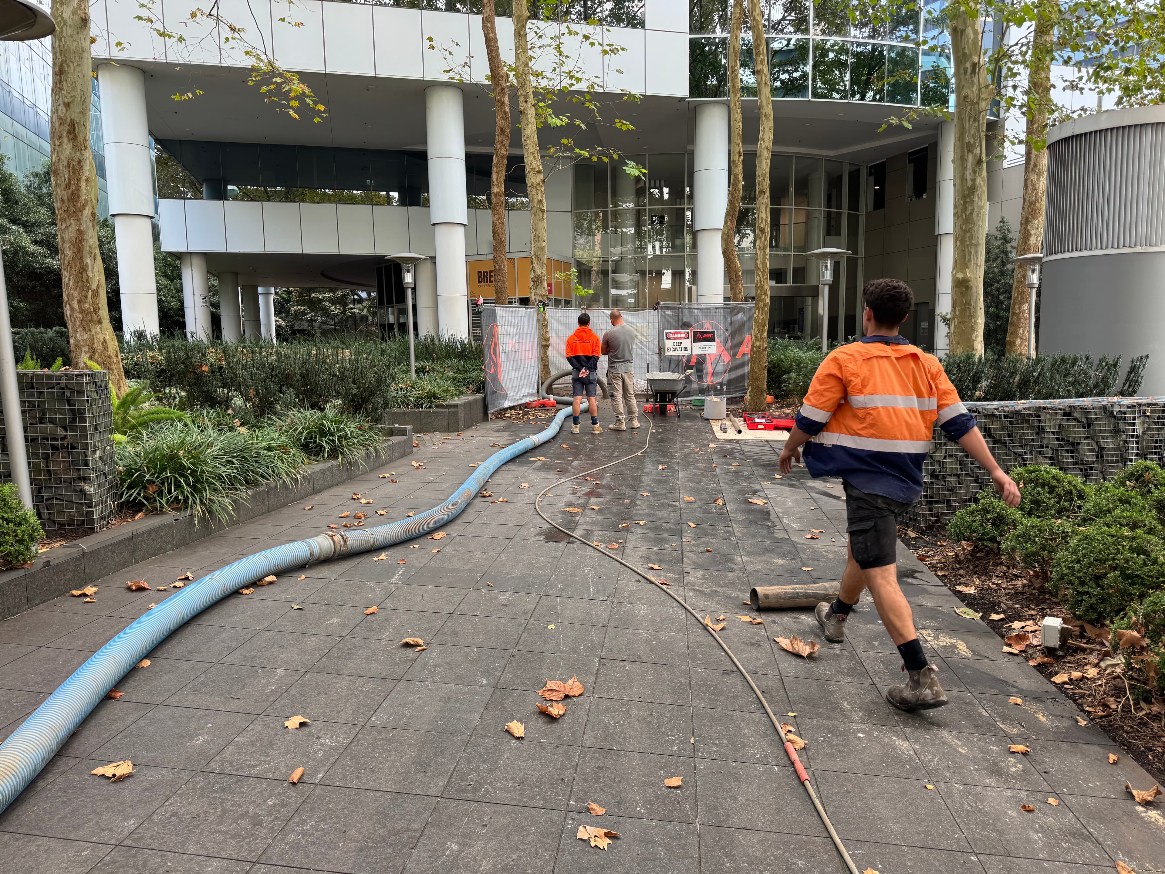 Commercial site set-up at Chatswood — fenced excavation zone in front of the building entrance.